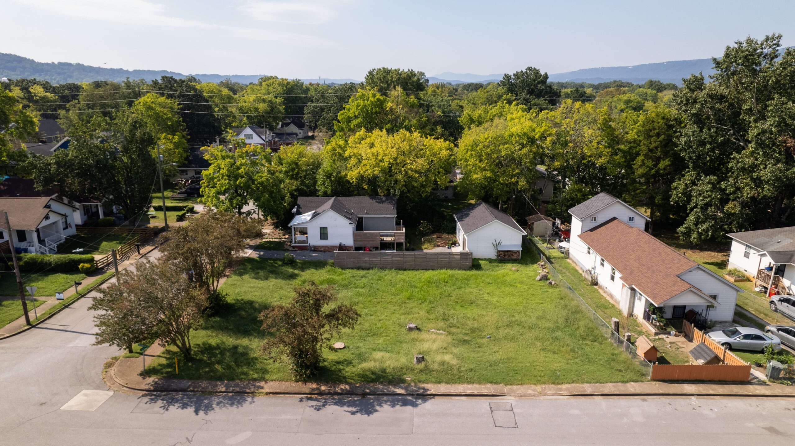 The vacant Beech Street lot before construction, looking across the neighborhood toward the ridges beyond
