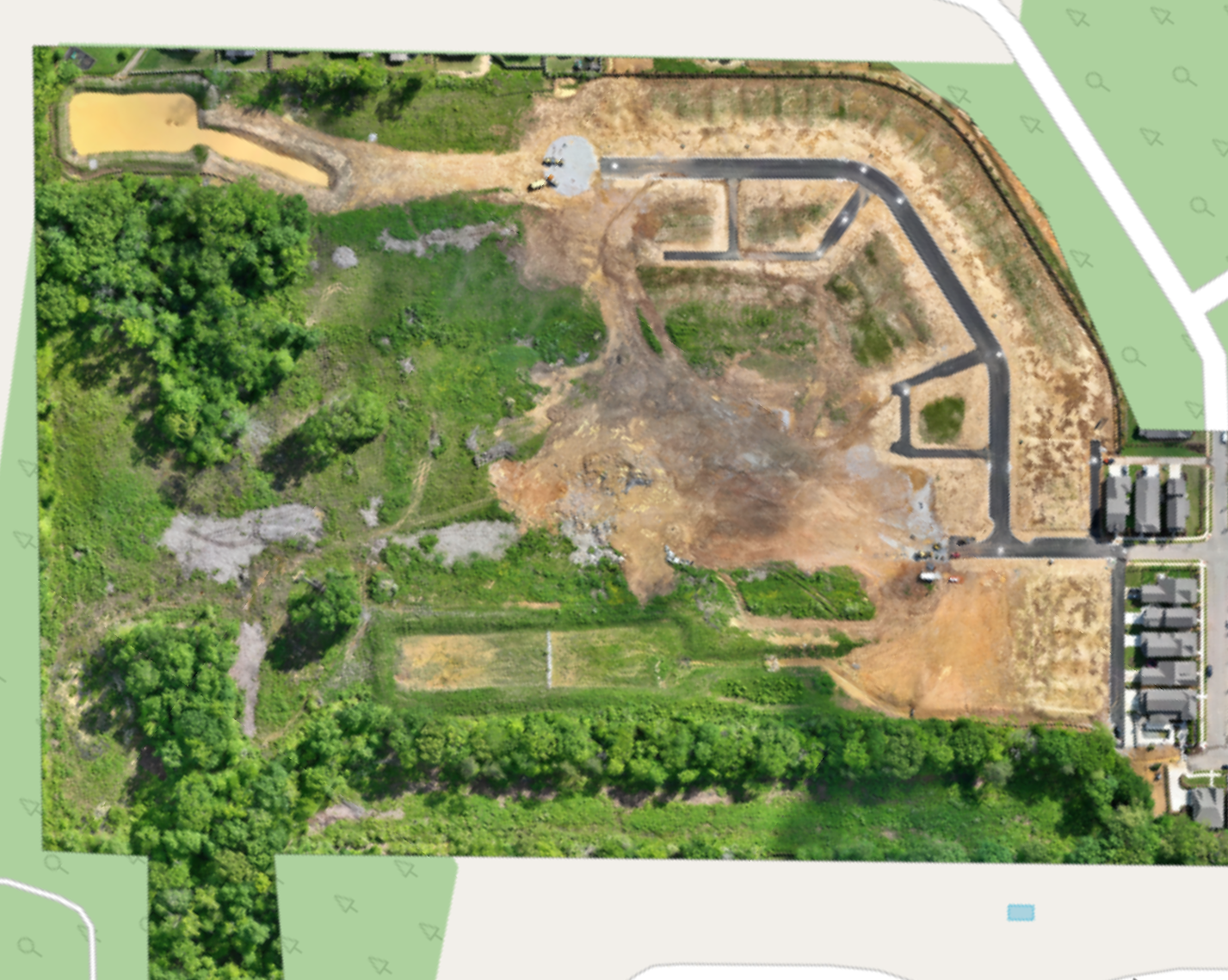Overhead orthomosaic of The Farmstead Phase 2 showing the completed street network, graded lots, detention pond and preserved woodland