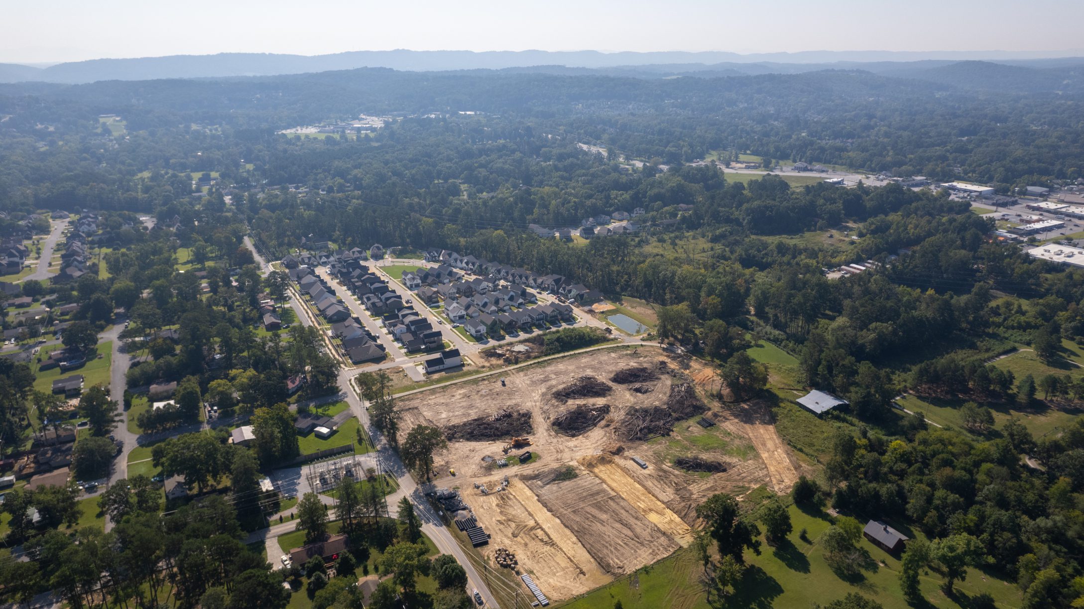 Aerial view of the Heritage Walk Phase 2A site cleared beside the finished Phase 1 streets