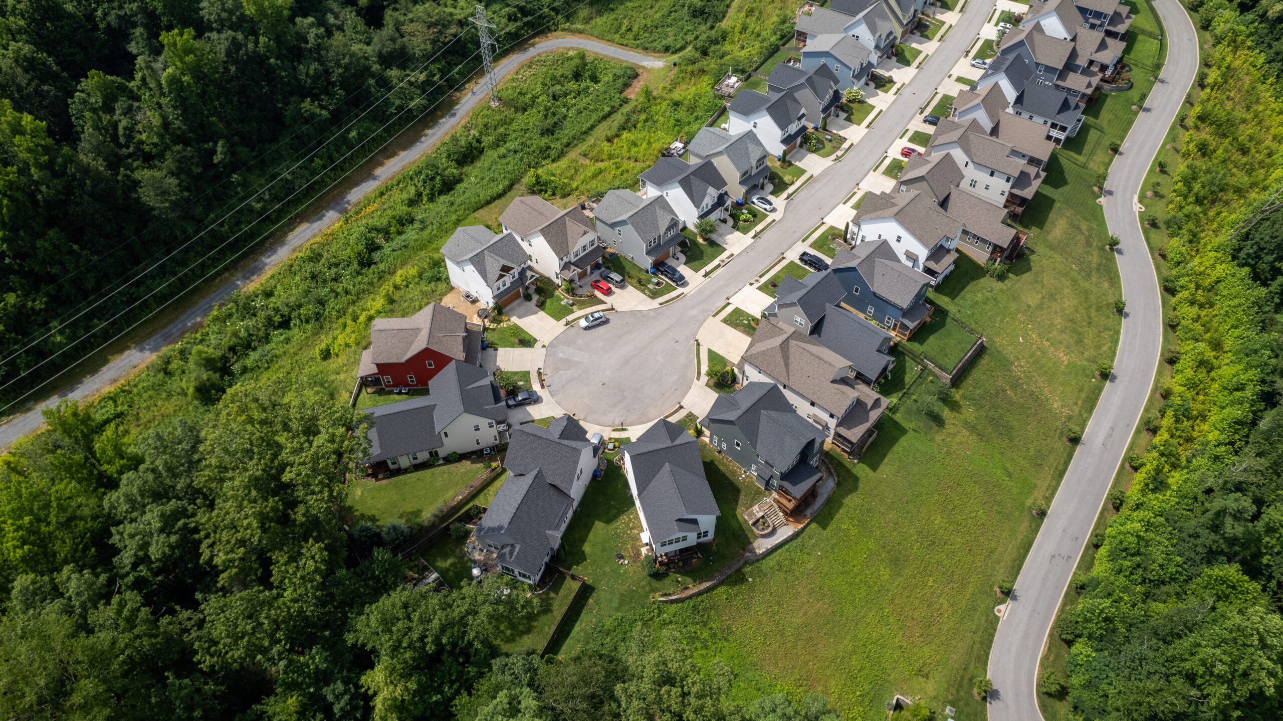 Overhead view of the cul-de-sac at the end of Northpoint Ridge, with homes around the turnaround and a power line easement cut through the trees