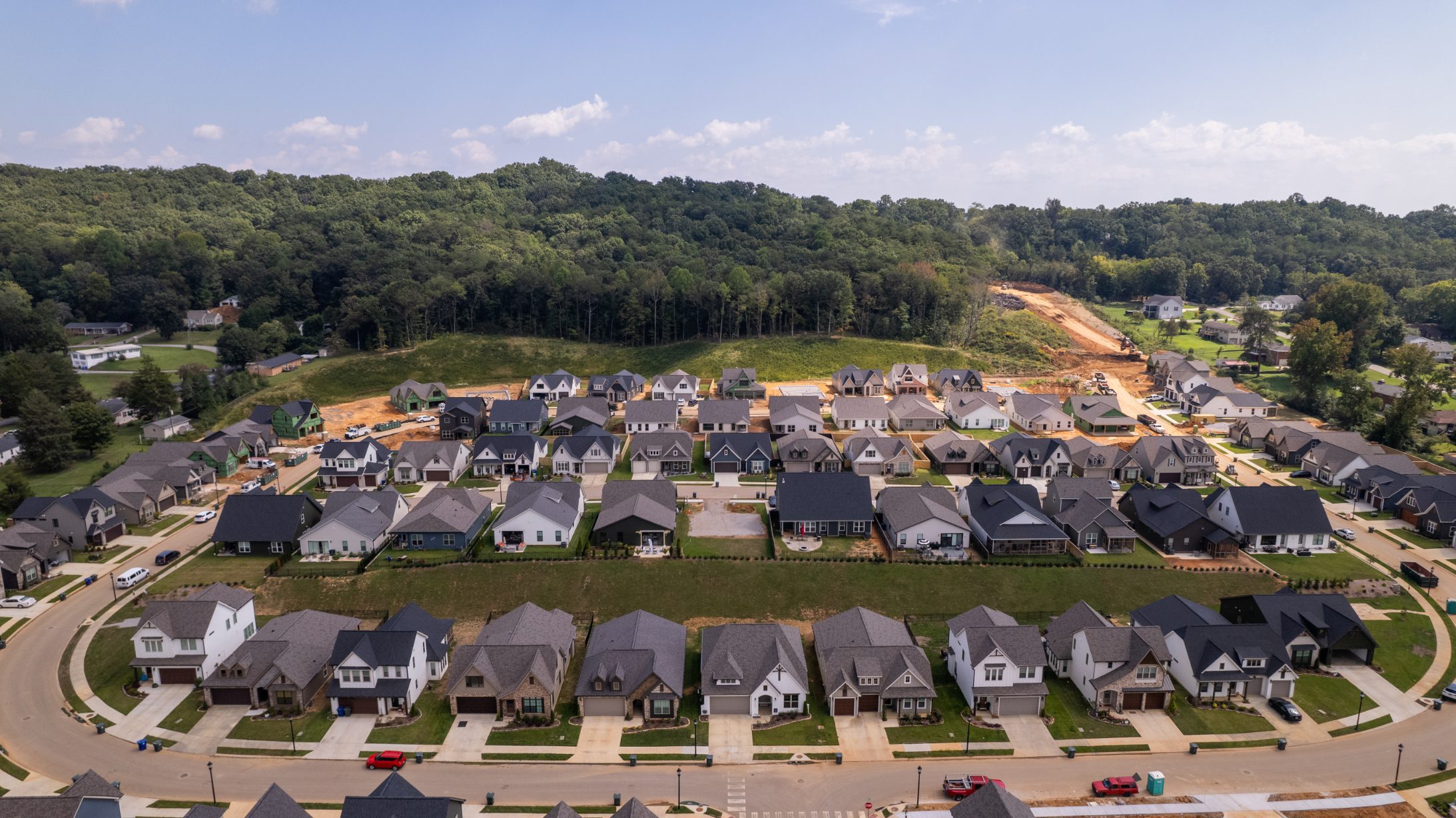 Overhead orthomosaic of Painted Ridge showing the looped street network, driveways, finished homes and lots still under construction